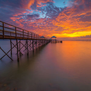 Scenic view of sea against orange sky