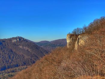 Scenic view of mountains against clear blue sky