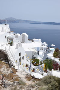 High angle view of buildings by sea against sky