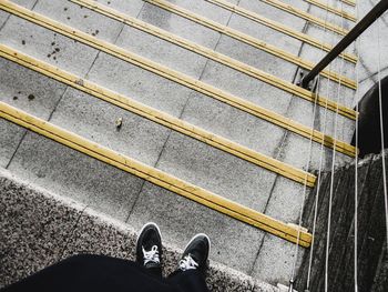 Low section of man standing on steps