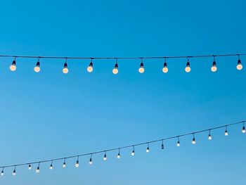 String wired bulbs on evening blue sky