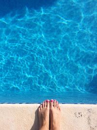 Low section of woman at swimming pool