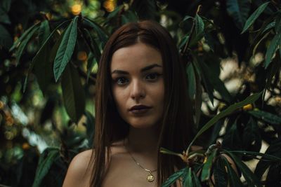 Portrait of beautiful woman amidst plants