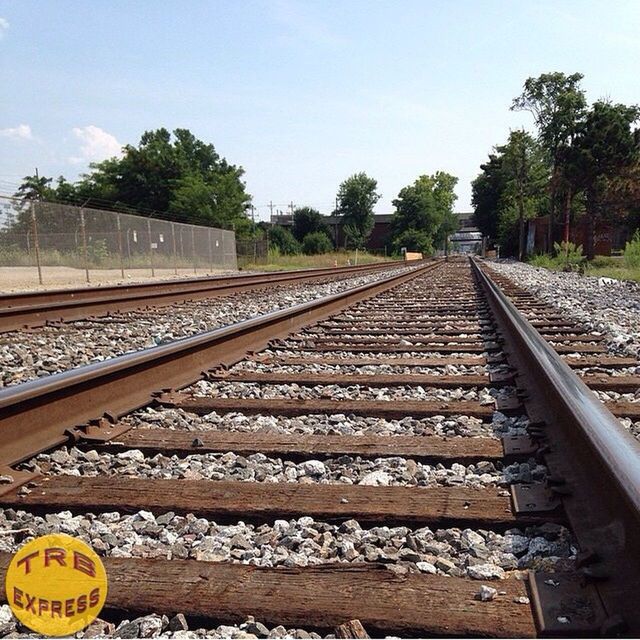 railroad track, rail transportation, transportation, public transportation, tree, railroad station, railroad station platform, railway track, train - vehicle, diminishing perspective, the way forward, travel, vanishing point, train, mode of transport, sky, day, clear sky, passenger train, outdoors