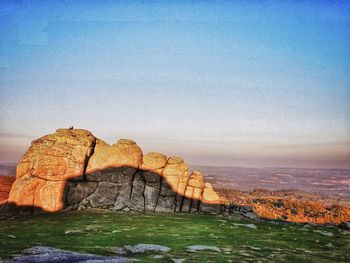 Rock formations on landscape against sky