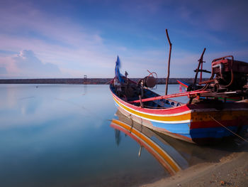 Boats moored in sea against sky