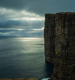 Scenic view of rock formation in sea against sky