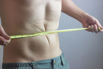 Midsection of woman holding hands