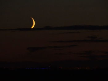 Silhouette landscape against sky at night