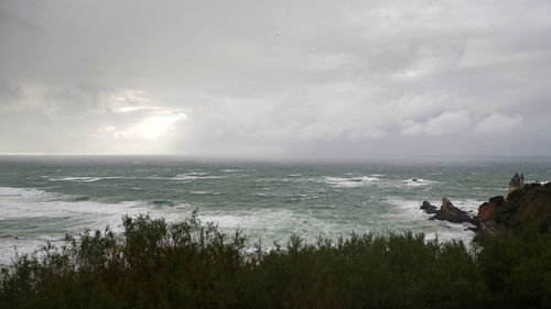 Scenic view of sea against storm clouds