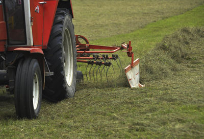 Hay turning machine in agriculture, on the field in summer