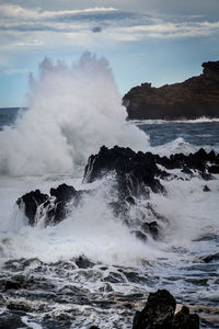 Waves splashing on rocks at shore