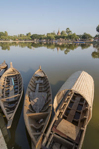 Panoramic view of boats moored in lake against sky