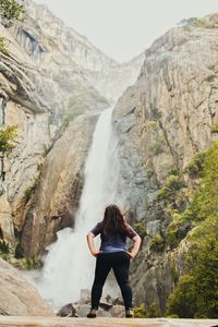 Rear view of woman on rocky mountain