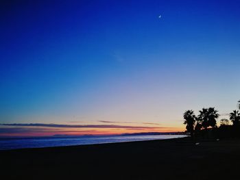 Scenic view of sea against clear sky at sunset