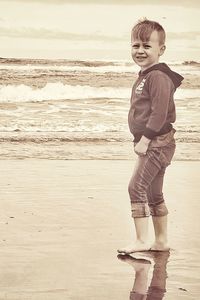 Full length of boy standing on beach