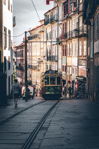 People walking on street amidst buildings in city