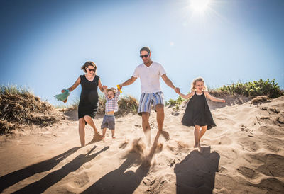 People on beach against sky