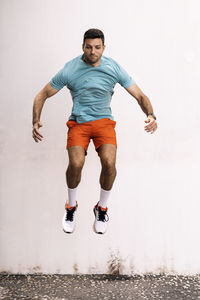 Isolated male athlete jumping outdoors