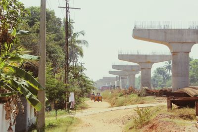 Bridge by trees against clear sky