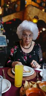 Woman with food on table in restaurant