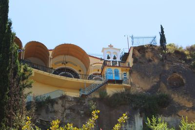 Low angle view of buildings against clear blue sky