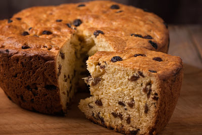 Slices of home made cake with raisins on wooden plate close up