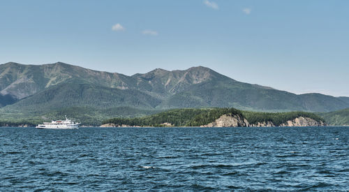 Chivyrkuisky bay of lake baikal. bolshoy kyltygey island, , buryatia, russia. white ship passing by.