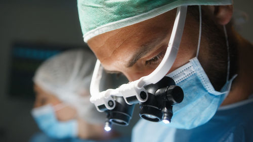 Doctor with surgical headlamp into operating room