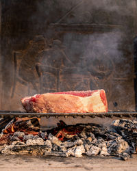 Italian roasted steak on a barbecue grill. appetizing piece of meat cooking on fire. bbq concept.
