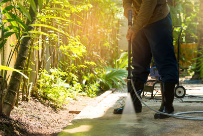 Low section of man standing by plants