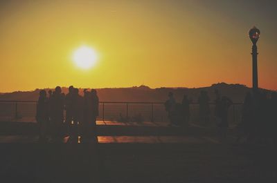 Silhouette of people at sunset