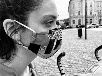 Close-up of young woman wearing flu mask on street