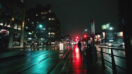 Illuminated city street at night
