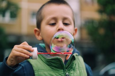 Close-up of boy playing with bubbles