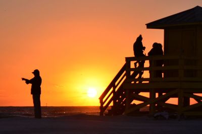 Silhouette of people at sunset