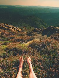 Low section of person relaxing on land