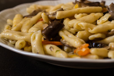 Cavatelli with pioppini mushrooms and yellow cherry tomatoes. homemade pasta