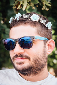 Close-up of smiling bearded man wearing wreath