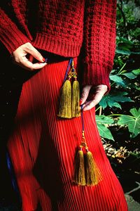 Close-up of woman with red leaves