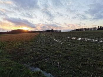 Scenic view of field against sky during sunset