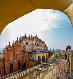 Low angle view of arch bridge and buildings against sky