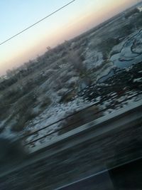 Close-up of snow covered landscape against sky