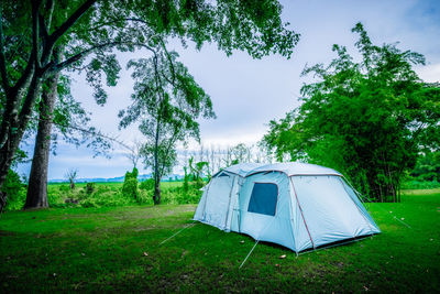 Tent on field against sky