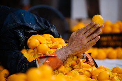 Person praying in thrown oranges