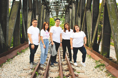 Portrait of people standing against the wall