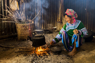 Woman preparing food while sitting at home