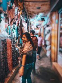 Portrait of smiling young woman standing in market