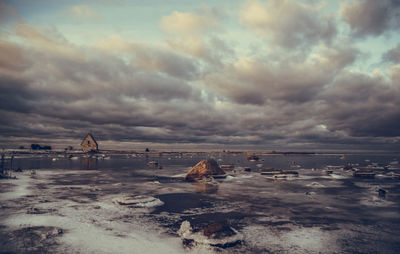 Scenic view of sea against cloudy sky