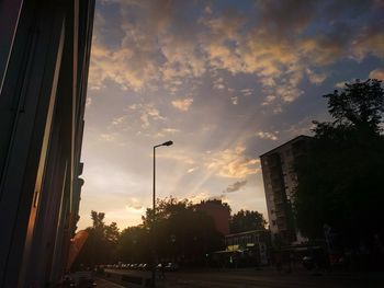 View of buildings against cloudy sky at sunset